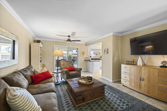 tiled living room featuring crown molding, ceiling fan, and a textured ceiling