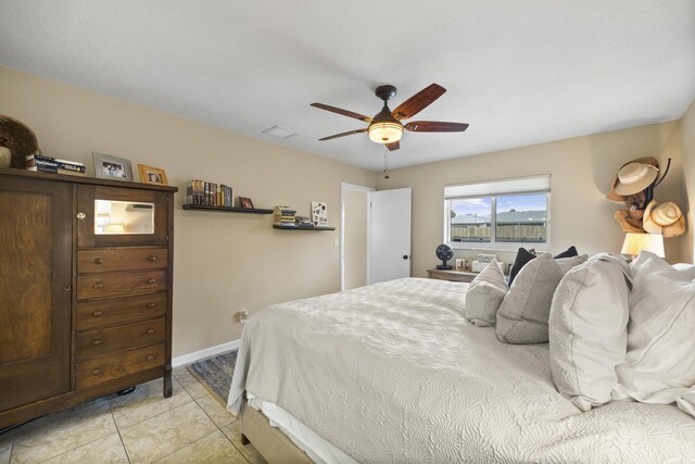 tiled bedroom with ceiling fan