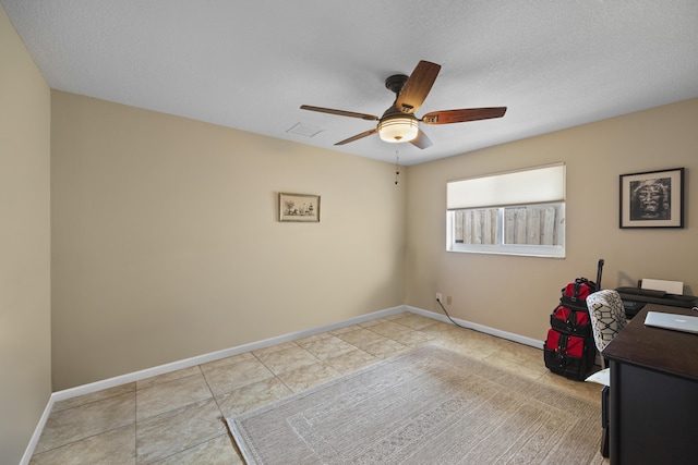 tiled home office with a textured ceiling and ceiling fan