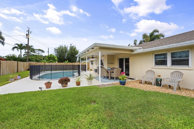 view of swimming pool with a yard and a patio