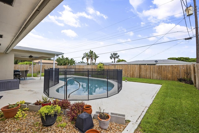 view of pool featuring a lawn and a patio