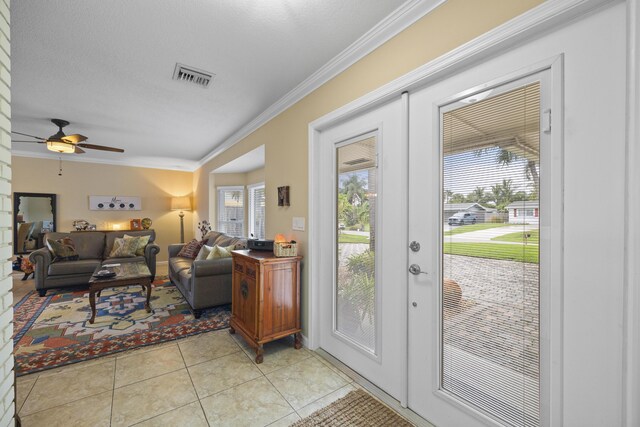 tiled living room with sink, ceiling fan, and crown molding