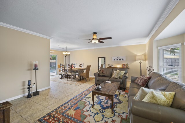 living room with crown molding, ceiling fan with notable chandelier, and light tile patterned floors