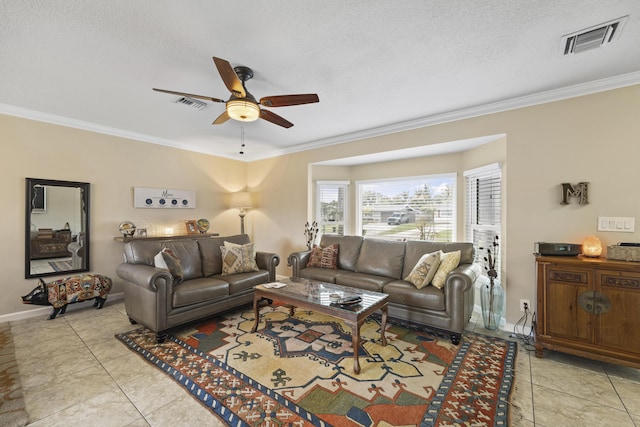 tiled living room with ceiling fan, ornamental molding, and a textured ceiling