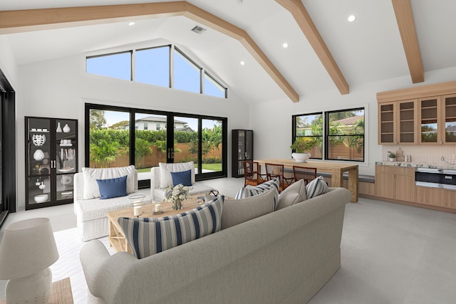 living room with beamed ceiling, high vaulted ceiling, and a healthy amount of sunlight