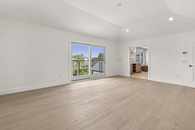 unfurnished living room with light hardwood / wood-style floors and lofted ceiling