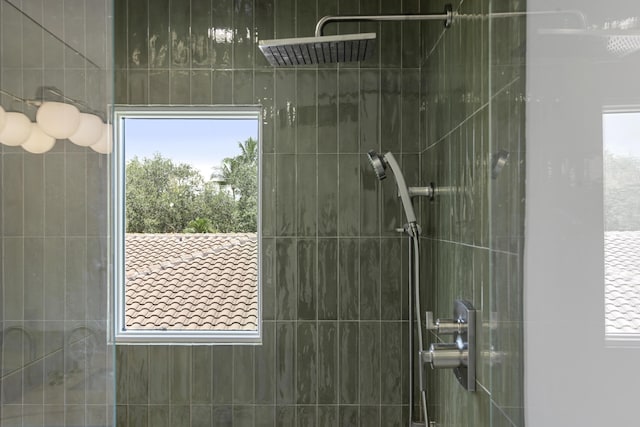 bathroom featuring plenty of natural light and a tile shower