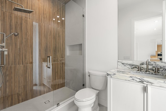 bathroom featuring vanity, toilet, and walk in shower