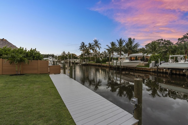 dock area featuring a yard and a water view