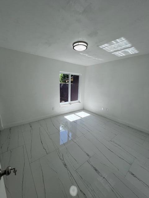 empty room featuring tile patterned floors