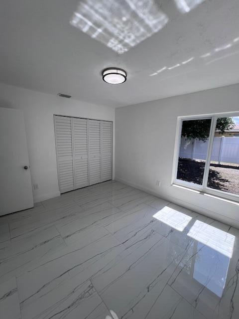 unfurnished bedroom featuring a closet