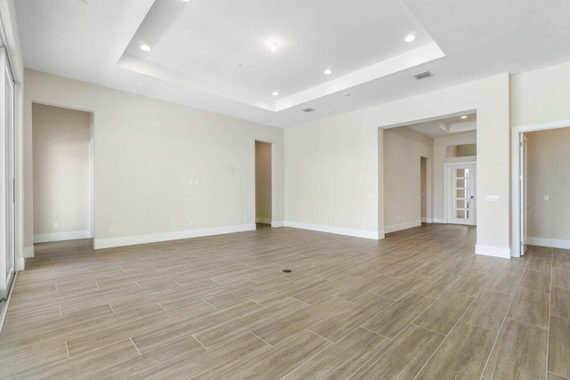 spare room with a raised ceiling