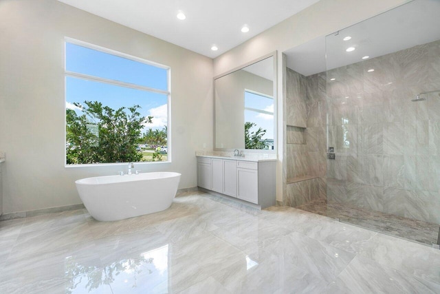 bathroom featuring vanity and independent shower and bath