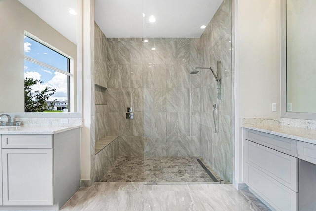 bathroom featuring vanity and tiled shower