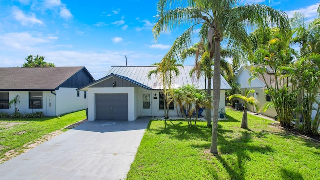 view of front of home featuring a garage and a front yard