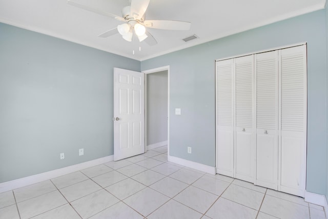 unfurnished bedroom featuring light tile patterned floors, a closet, and ceiling fan