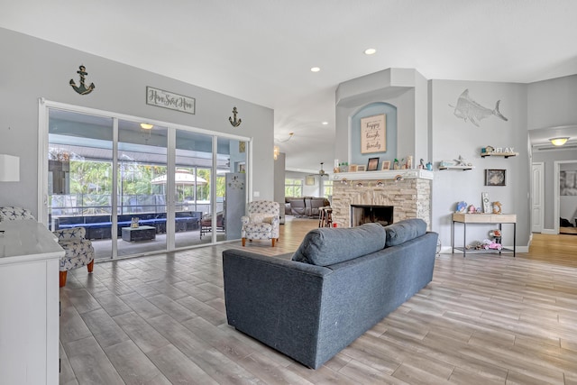 living room with a stone fireplace