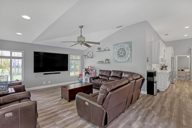 living room featuring light hardwood / wood-style floors, ceiling fan, and lofted ceiling