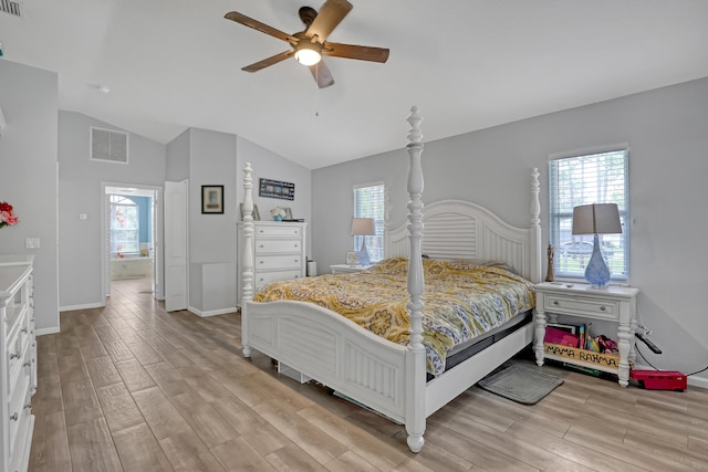 bedroom featuring ceiling fan, light hardwood / wood-style floors, and lofted ceiling