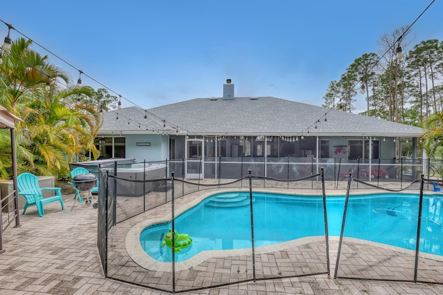 view of pool featuring a sunroom and a patio