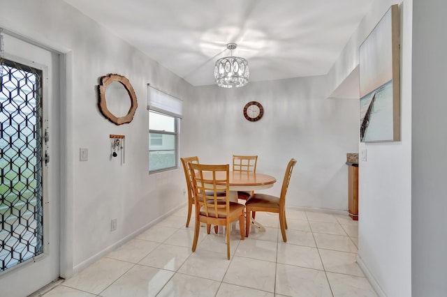 dining area with a notable chandelier and light tile patterned floors