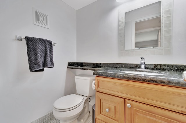 bathroom with vanity, toilet, and tile patterned flooring