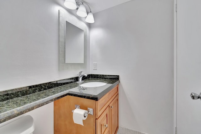 bathroom with vanity, toilet, and tile patterned floors