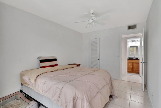 tiled bedroom featuring sink, a closet, and ceiling fan