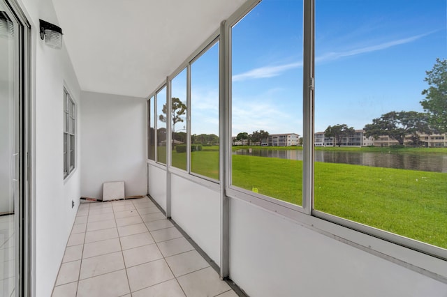 unfurnished sunroom featuring a water view and a healthy amount of sunlight