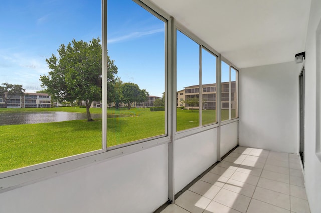 unfurnished sunroom with a water view