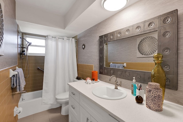 full bathroom featuring toilet, vanity, tile patterned floors, and shower / bath combo with shower curtain