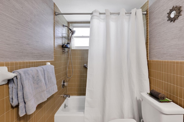 bathroom with shower / bath combination with curtain, toilet, and tile walls