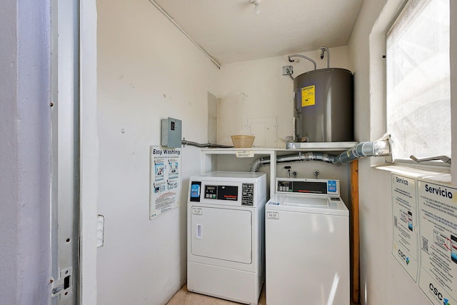 clothes washing area with washer and dryer and water heater