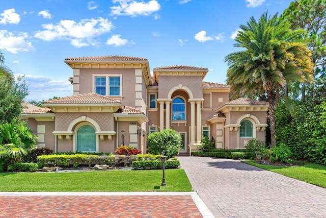 mediterranean / spanish house featuring a front lawn