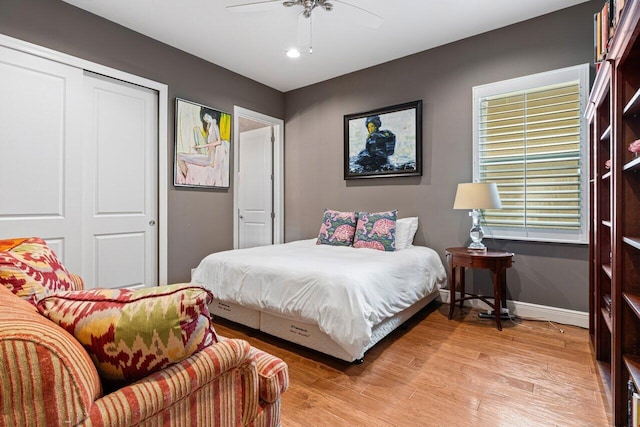 bedroom featuring light hardwood / wood-style flooring, a closet, and ceiling fan