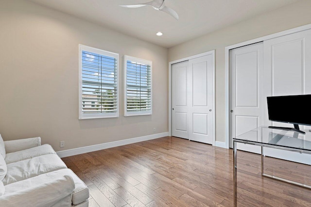 home office with wood-type flooring and ceiling fan