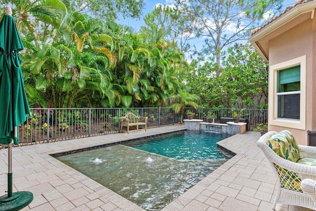 view of pool featuring pool water feature and a patio area