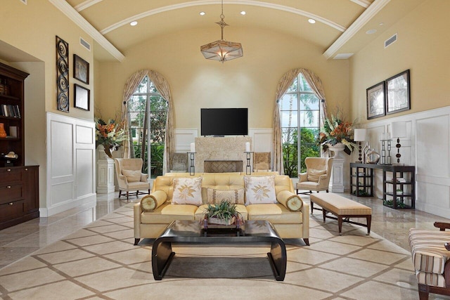 tiled living room with crown molding, high vaulted ceiling, and a high end fireplace