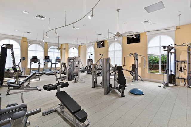 exercise room featuring light colored carpet and ceiling fan