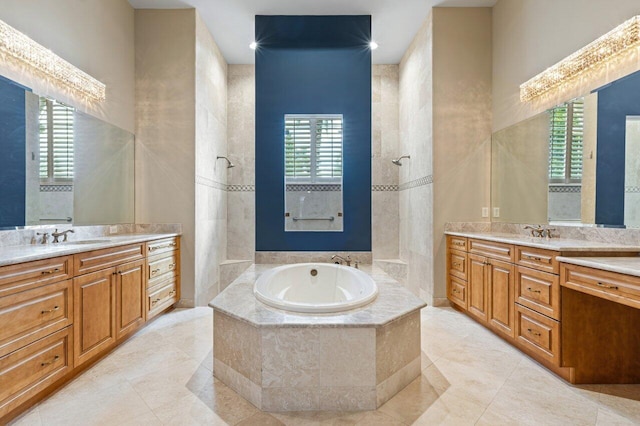 bathroom with a healthy amount of sunlight, tile patterned floors, and vanity