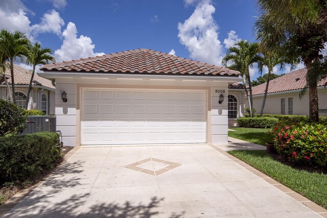 mediterranean / spanish-style house with a garage