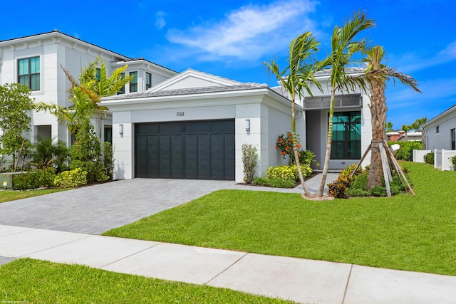 view of front facade with a garage and a front lawn