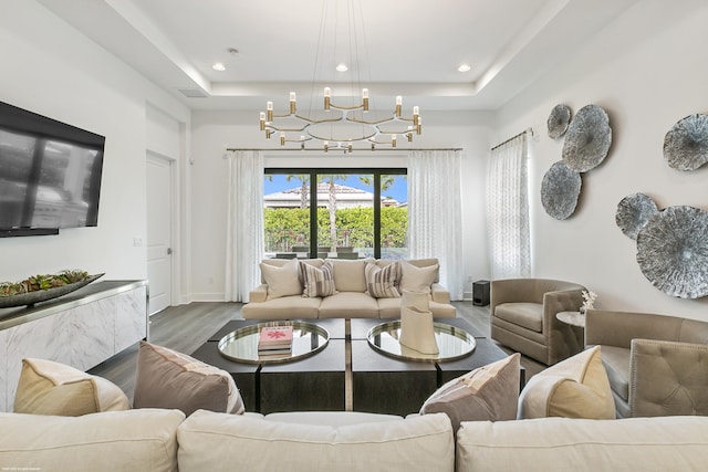 13173 Faberge Pl, Palm Beach Gardens, FL 33418 - living area featuring wood finished floors, a tray ceiling, a chandelier, recessed lighting, and baseboards