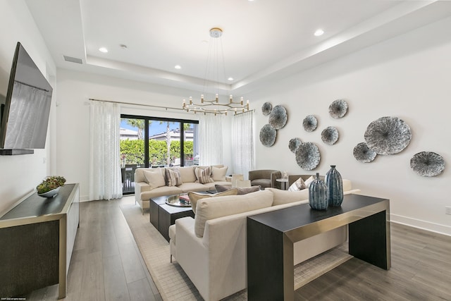 13173 Faberge Pl, Palm Beach Gardens, FL 33418 - living room with a raised ceiling, a chandelier, recessed lighting, wood finished floors, and baseboards