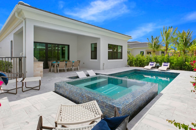 view of swimming pool with an in ground hot tub and a patio area