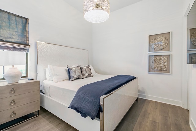 bedroom with dark hardwood / wood-style floors