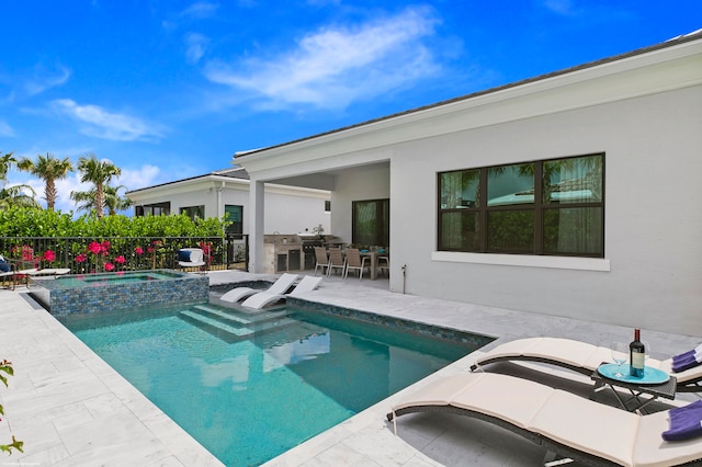 view of swimming pool with a patio area and an in ground hot tub