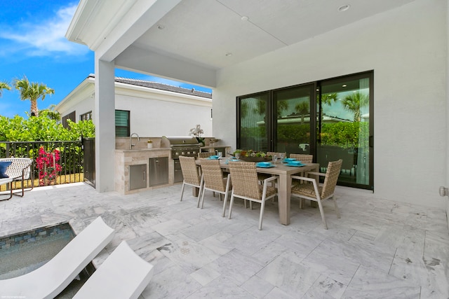 view of patio with grilling area, exterior kitchen, and sink