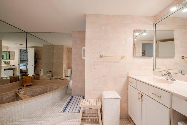 bathroom featuring tile walls, tile patterned flooring, and vanity