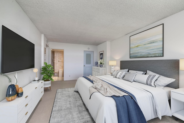 carpeted bedroom with a textured ceiling and ensuite bathroom